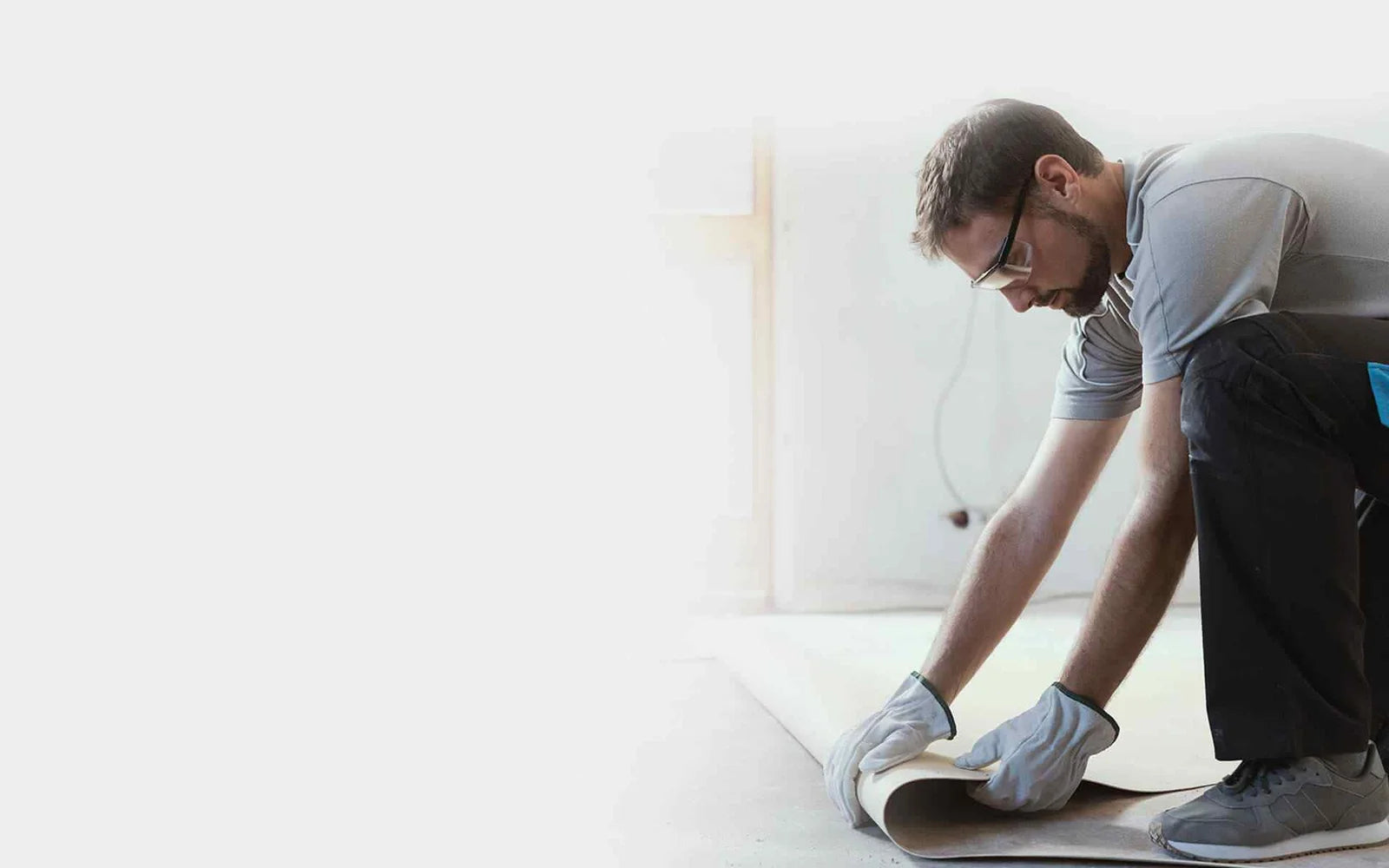 A man wearing safety glasses and working on a renovation project